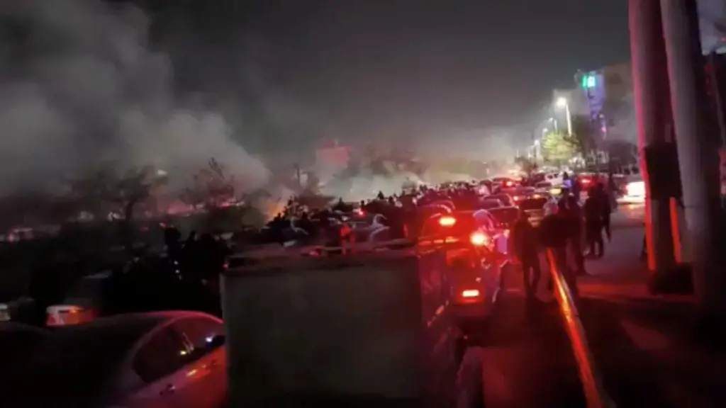 Smoke-rises-as-protesters-gather-amid-evolving-anti-government-unrest-in-Mashhad-Razavi-Khorasan-province-Iran-released-on-January-10-2026-in-this-screen-grab-obtained-from-a-social-media-video-SOCIAL-MEDIA-via-REUTERS-THIS-IMAGE-HAS-BEEN-SUPPLIED-BY-A-THIRD-PARTY-MANDATORY-CREDIT-NO-RESALES-NO-ARCHIVES-Verification-lines-Reuters-was-able-to-confirm-the-location-from-buildings-traffic-signboard-and-overbridge-which-matched-with-file-and-satellite-imagery-Date-of-the-video-could-not-be-verified-However-several-corroborating-videos-uploaded-on-social-media-showed-similar-scenes-along-Vakil-Abad-highway-in-Mashhad