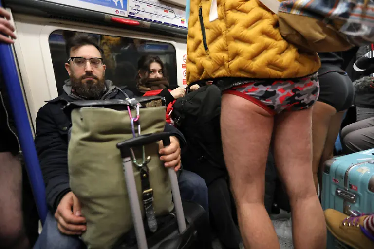 January-12-2025-London-England-United-Kingdom-Revellers-ride-a-Piccadilly-line-train-towards-South-Kensington-mixing-with-trousered-travellers-Those-participating-in-this-annual-event-do-for-no-reason-other-than-to-have-fun-They-gather-go-onto-the-London-Underground-system-remove-their-trousers-and-ride-around-the-system-for-a-bit-The-tradition-started-in-New-York-in-2002-the-whole-point-is-to-remain-as-nonchalant-as-possible-despite-the-fact-that-participants-have-no-trousers-on