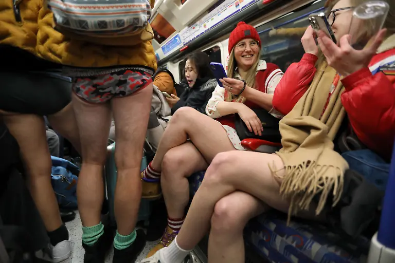 January-12-2025-London-England-United-Kingdom-Revellers-sit-on-a-Piccadilly-line-train-wearing-no-trousers-Those-participating-in-this-annual-event-do-for-no-reason-other-than-to-have-fun-They-gather-go-onto-the-London-Underground-system-remove-their-trousers-and-ride-around-the-system-for-a-bit-The-tradition-started-in-New-York-in-2002-the-whole-point-is-to-remain-as-nonchalant-as-possible-despite-the-fact-that-participants-have-no-trousers-on