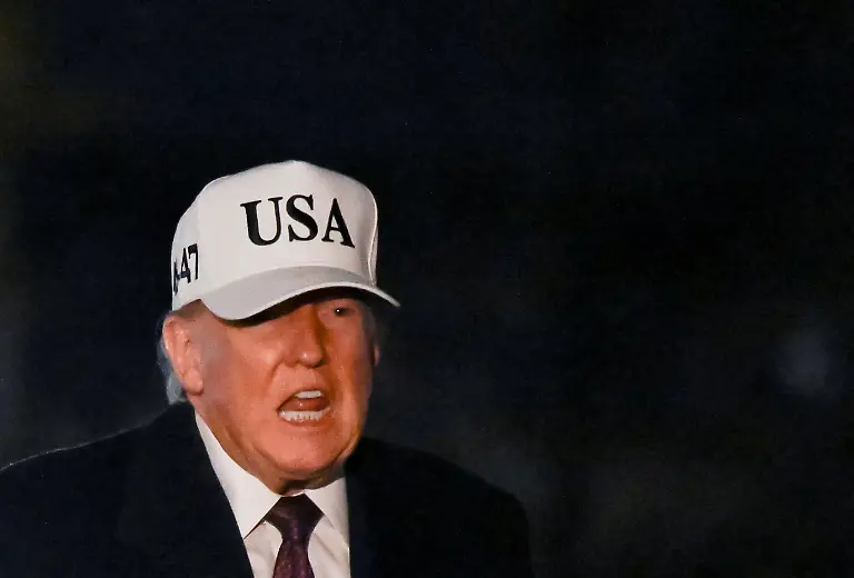 U-S-President-Donald-Trump-reacts-while-walking-after-arriving-on-the-South-Lawn-aboard-Marine-One-at-the-White-House-in-Washington-D-C-U-S-January-11-2026