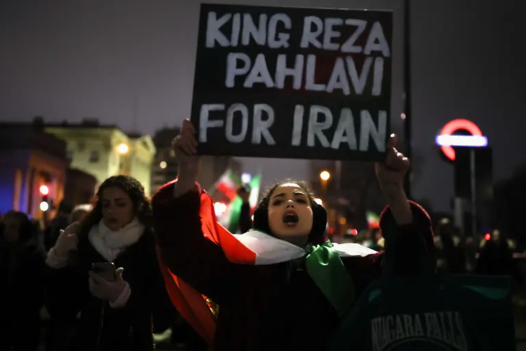 A-woman-displays-a-sign-as-demonstrators-walk-toward-the-Iranian-embassy-during-a-rally-in-support-of-nationwide-protests-in-Iran-in-London-Britain-January-11-2026