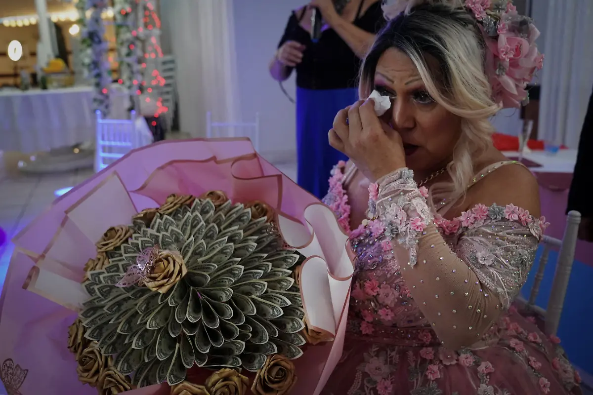 Noemi-Martinez-54-cries-as-she-receives-a-puffy-bouquet-made-of-bills-known-as-a-ramo-buchon-during-a-quinceanera-celebration-at-a-ballroom-in-Houston-Texas-U-S-May-14-2025-Martinez-and-other-transgender-Latina-immigrants-were-recently-able-to-celebrate-this-year-as-quinceaneras-literally-translated-as-15-year-olds-thanks-to-the-Organizacion-Latina-de-Trans-en-Texas-a-group-promoting-rights-for-LGBTQ-people-including-transgender-women-from-Latin-America-It-s-a-moment-of-joy-and-excitement-with-a-sense-of-suspense-So-beautiful-because-they-OLTT-are-giving-us-that-space-for-ourselves-to-express-those-beautiful-feelings-Martinez-said-What-we-didn-t-have-as-girls-we-now-have-as-adults-REUTERS-Gabriel-V-Cardenas-SEARCH-CARDENAS-U-S-QUINCEANERAS-FOR-THIS-STORY-SEARCH-WIDER-IMAGE-FOR-ALL-STORIES-THIS-IMAGE-IS-ONLY-FOR-USE-WITH-THE-STORY-USA-LGBTQ-QUINCEANERAS-NO-STANDALONE-USES