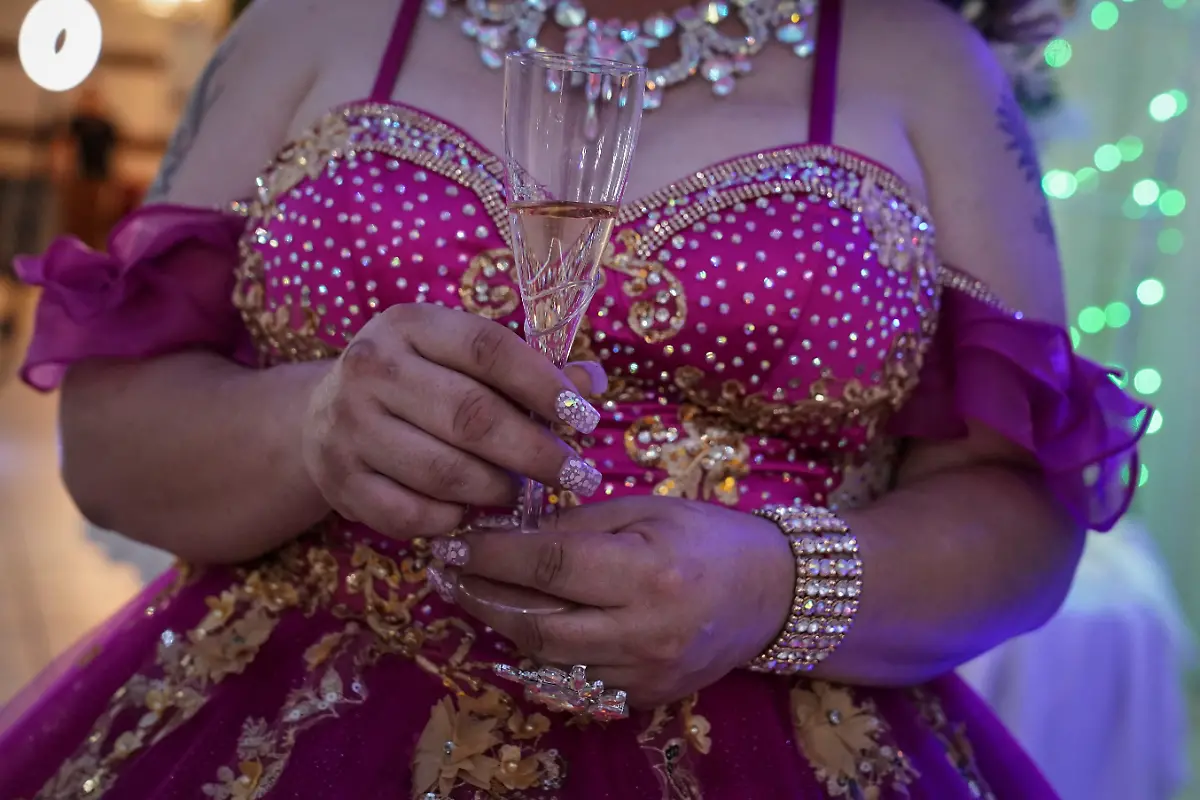 Kassandra-Rivas-51-holds-a-glass-during-a-toast-at-a-ballroom-in-Houston-Texas-U-S-May-14-2025-Rivas-and-other-transgender-Latina-immigrants-were-recently-able-to-celebrate-this-year-as-quinceaneras-thanks-to-the-Organizacion-Latina-de-Trans-en-Texas-a-group-promoting-rights-for-LGBTQ-people-including-transgender-women-from-Latin-America-Something-inside-me-held-a-longing-to-experience-this-moment-as-a-girl-as-a-15-year-old-Rivas-said-I-imagined-myself-standing-before-the-priest-in-church-wearing-a-dress-like-any-other-woman-REUTERS-Gabriel-V-Cardenas-SEARCH-CARDENAS-U-S-QUINCEANERAS-FOR-THIS-STORY-SEARCH-WIDER-IMAGE-FOR-ALL-STORIES-THIS-IMAGE-IS-ONLY-FOR-USE-WITH-THE-STORY-USA-LGBTQ-QUINCEANERAS-NO-STANDALONE-USES