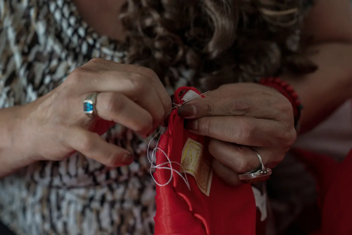 Dilian-Quijano-58-fixes-her-quinceanera-dress-as-she-gets-ready-at-a-hotel-in-Houston-Texas-U-S-May-14-2025-Quijano-and-other-transgender-Latina-immigrants-were-recently-able-to-celebrate-this-year-as-quinceaneras-literally-translated-as-15-year-olds-thanks-to-the-Organizacion-Latina-de-Trans-en-Texas-a-group-promoting-rights-for-LGBTQ-people-including-transgender-women-from-Latin-America-I-would-see-them-quinceaneras-wear-beautiful-dresses-I-would-see-the-long-dress-and-them-dancing-and-I-would-say-to-myself-How-beautiful-I-would-like-to-have-a-dress-like-that-someday-but-I-never-thought-that-that-would-become-true-Quijano-said-REUTERS-Gabriel-V-Cardenas-SEARCH-CARDENAS-U-S-QUINCEANERAS-FOR-THIS-STORY-SEARCH-WIDER-IMAGE-FOR-ALL-STORIES-THIS-IMAGE-IS-ONLY-FOR-USE-WITH-THE-STORY-USA-LGBTQ-QUINCEANERAS-NO-STANDALONE-USES