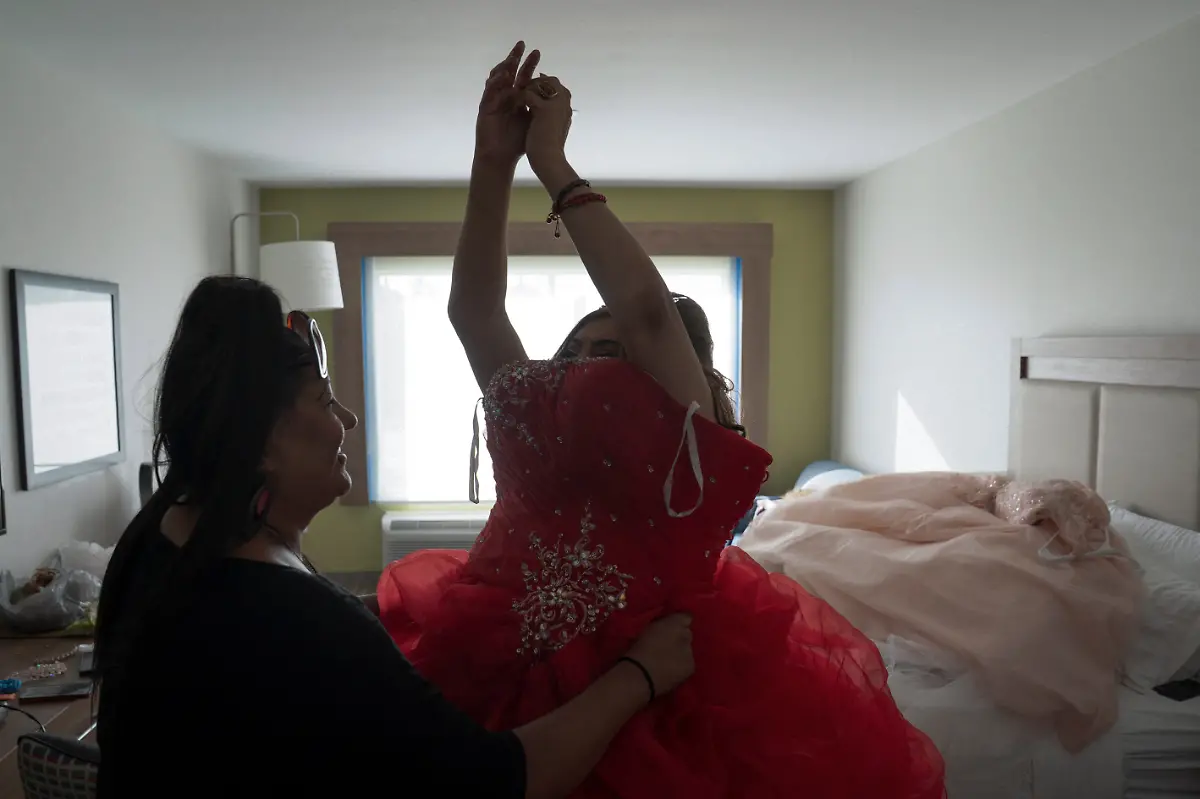 Dilian-Quijano-58-is-assisted-by-Marlen-Vazquez-as-she-gets-ready-for-her-quinceanera-at-a-hotel-in-Houston-Texas-U-S-May-14-2025-Quijano-and-other-transgender-Latina-immigrants-were-recently-able-to-celebrate-this-year-as-quinceaneras-literally-translated-as-15-year-olds-thanks-to-the-Organizacion-Latina-de-Trans-en-Texas-a-group-promoting-rights-for-LGBTQ-people-including-transgender-women-from-Latin-America-I-would-see-them-quinceaneras-wear-beautiful-dresses-I-would-see-the-long-dress-and-them-dancing-and-I-would-say-to-myself-How-beautiful-I-would-like-to-have-a-dress-like-that-someday-but-I-never-thought-that-that-would-become-true-Quijano-said-REUTERS-Gabriel-V-Cardenas-SEARCH-CARDENAS-U-S-QUINCEANERAS-FOR-THIS-STORY-SEARCH-WIDER-IMAGE-FOR-ALL-STORIES-THIS-IMAGE-IS-ONLY-FOR-USE-WITH-THE-STORY-USA-LGBTQ-QUINCEANERAS-NO-STANDALONE-USES