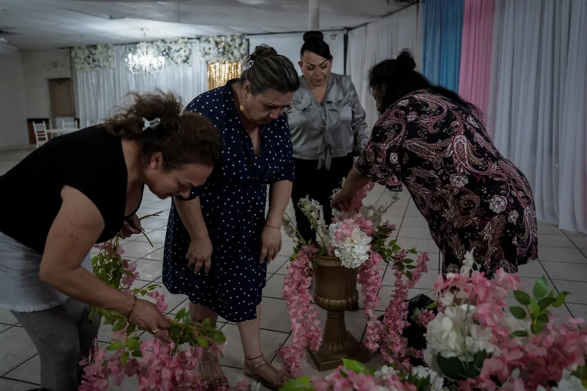 From-left-to-right-Jessica-Flores-49-Kassandra-Rivas-51-Ana-Andrea-Molina-and-Dayana-Torres-prepare-flower-arrangements-for-the-quinceanera-celebration-at-a-ballroom-in-Houston-Texas-U-S-May-13-2025-Rivas-and-other-transgender-Latina-immigrants-were-recently-able-to-celebrate-this-year-as-quinceaneras-thanks-to-the-Organizacion-Latina-de-Trans-en-Texas-a-group-promoting-rights-for-LGBTQ-people-including-transgender-women-from-Latin-America-Something-inside-me-held-a-longing-to-experience-this-moment-as-a-girl-as-a-15-year-old-Rivas-said-I-imagined-myself-standing-before-the-priest-in-church-wearing-a-dress-like-any-other-woman-REUTERS-Gabriel-V-Cardenas-SEARCH-CARDENAS-U-S-QUINCEANERAS-FOR-THIS-STORY-SEARCH-WIDER-IMAGE-FOR-ALL-STORIES-THIS-IMAGE-IS-ONLY-FOR-USE-WITH-THE-STORY-USA-LGBTQ-QUINCEANERAS-NO-STANDALONE-USES