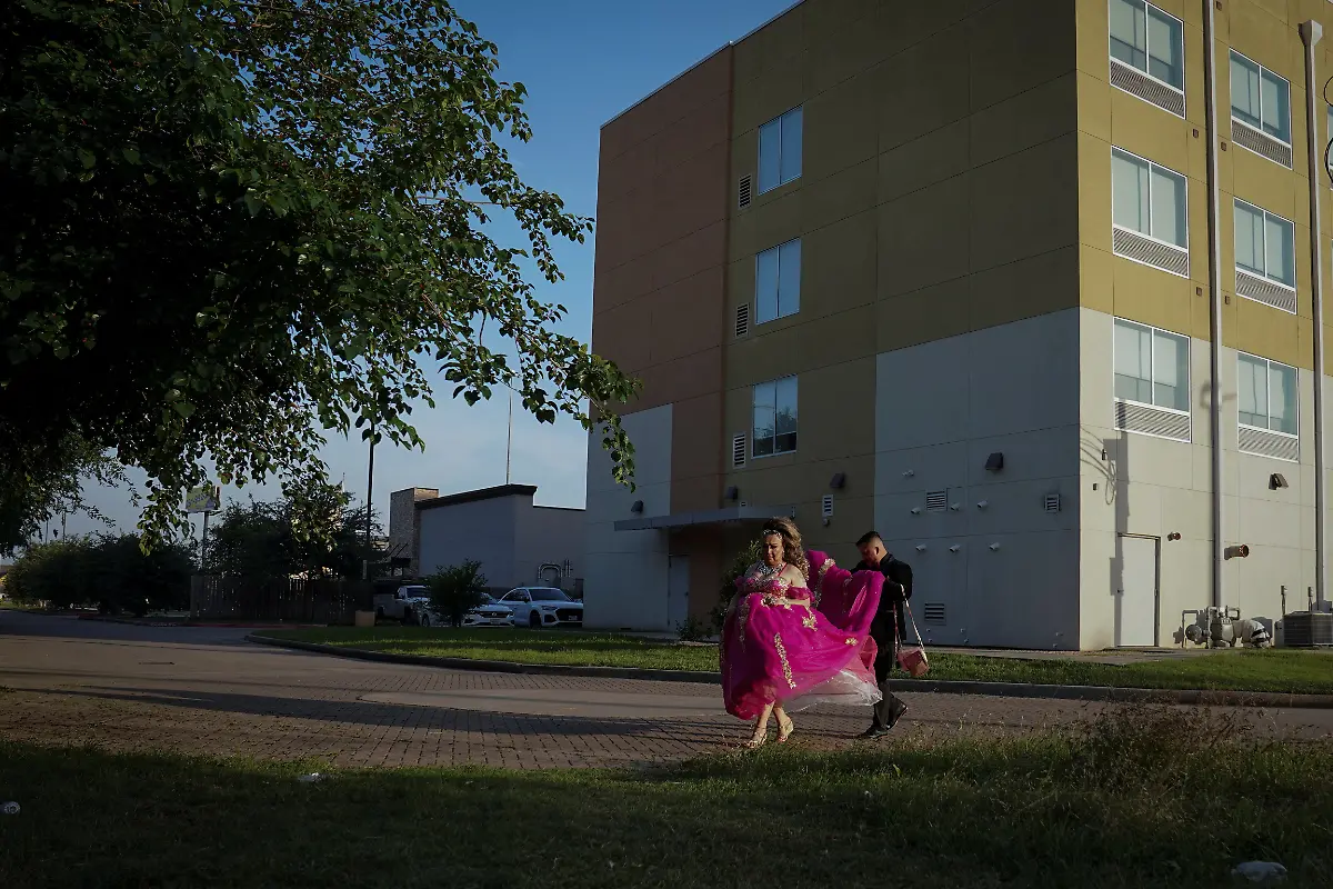 Kassandra-Rivas-51-is-assisted-by-her-chambelan-Jorge-L-Euceda-31-a-traditional-male-escort-in-a-quinceanera-in-Houston-Texas-U-S-May-14-2025-Rivas-and-other-transgender-Latina-immigrants-were-recently-able-to-celebrate-this-year-as-quinceaneras-thanks-to-the-Organizacion-Latina-de-Trans-en-Texas-a-group-promoting-rights-for-LGBTQ-people-including-transgender-women-from-Latin-America-Something-inside-me-held-a-longing-to-experience-this-moment-as-a-girl-as-a-15-year-old-Rivas-said-I-imagined-myself-standing-before-the-priest-in-church-wearing-a-dress-like-any-other-woman-REUTERS-Gabriel-V-Cardenas-SEARCH-CARDENAS-U-S-QUINCEANERAS-FOR-THIS-STORY-SEARCH-WIDER-IMAGE-FOR-ALL-STORIES-THIS-IMAGE-IS-ONLY-FOR-USE-WITH-THE-STORY-USA-LGBTQ-QUINCEANERAS-NO-STANDALONE-USES