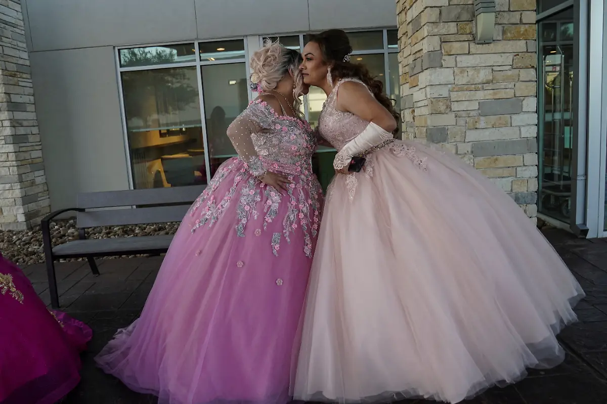 Noemi-Martinez-L-54-and-Jessica-Flores-49-kiss-as-they-get-ready-to-enter-the-limousine-that-will-take-them-to-the-ballroom-in-Houston-Texas-U-S-May-14-2025-Flores-and-other-transgender-Latina-immigrants-were-recently-able-to-celebrate-this-year-as-quinceaneras-literally-translated-as-15-year-olds-thanks-to-the-Organizacion-Latina-de-Trans-en-Texas-a-group-promoting-rights-for-LGBTQ-people-including-transgender-women-from-Latin-America-I-am-very-excited-I-still-have-that-feeling-from-when-I-was-a-little-girl-that-it-s-going-to-come-true-today-said-Flores-Truly-I-feel-that-excitement-as-if-I-were-fifteen-years-old-REUTERS-Gabriel-V-Cardenas-SEARCH-CARDENAS-U-S-QUINCEANERAS-FOR-THIS-STORY-SEARCH-WIDER-IMAGE-FOR-ALL-STORIES-THIS-IMAGE-IS-ONLY-FOR-USE-WITH-THE-STORY-USA-LGBTQ-QUINCEANERAS-NO-STANDALONE-USES