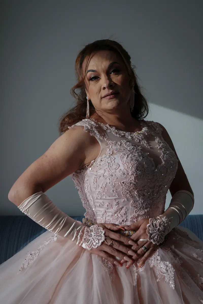 Jessica-Flores-49-poses-for-a-photo-in-her-quinceanera-dress-at-a-hotel-in-Houston-Texas-U-S-May-14-2025-Flores-and-other-transgender-Latina-immigrants-were-recently-able-to-celebrate-this-year-as-quinceaneras-literally-translated-as-15-year-olds-thanks-to-the-Organizacion-Latina-de-Trans-en-Texas-a-group-promoting-rights-for-LGBTQ-people-including-transgender-women-from-Latin-America-I-am-very-excited-I-still-have-that-feeling-from-when-I-was-a-little-girl-that-it-s-going-to-come-true-today-said-Flores-Truly-I-feel-that-excitement-as-if-I-were-fifteen-years-old-REUTERS-Gabriel-V-Cardenas-SEARCH-CARDENAS-U-S-QUINCEANERAS-FOR-THIS-STORY-SEARCH-WIDER-IMAGE-FOR-ALL-STORIES-THIS-IMAGE-IS-ONLY-FOR-USE-WITH-THE-STORY-USA-LGBTQ-QUINCEANERAS-NO-STANDALONE-USES