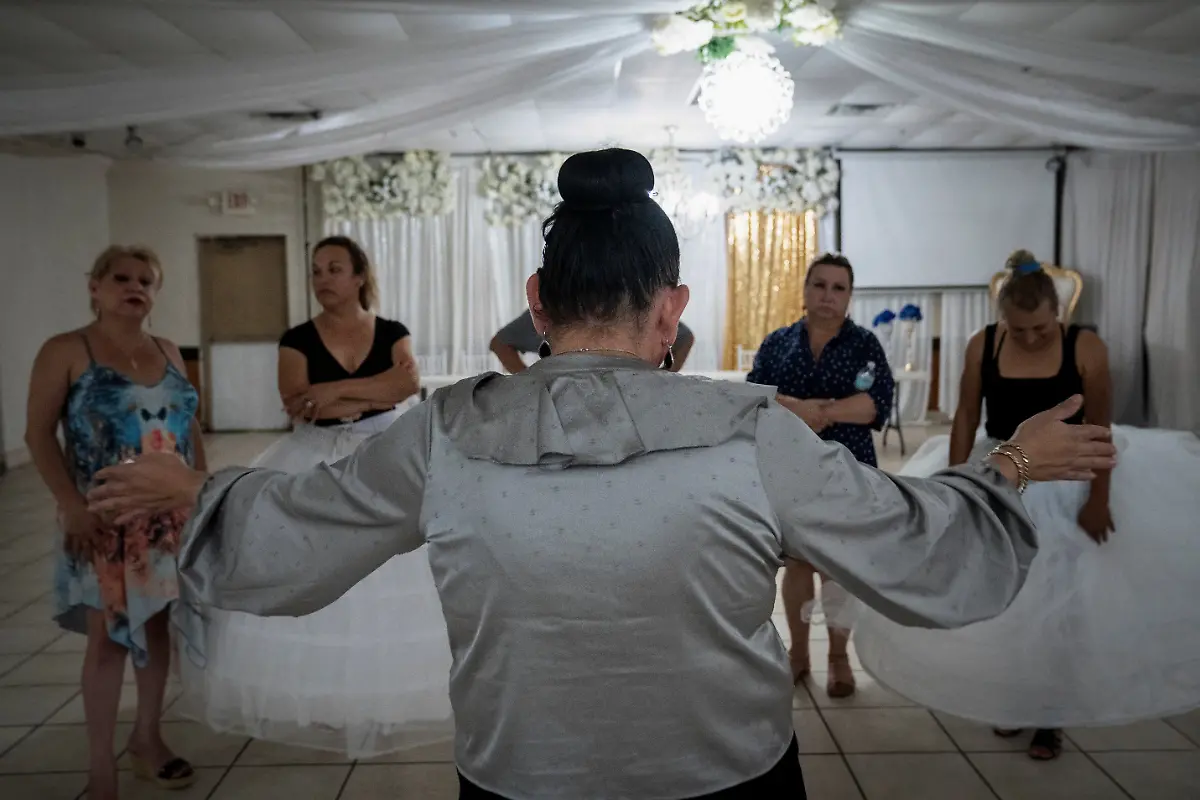 Ana-Andrea-Molina-C-founder-of-OLTT-Organizacion-Latina-de-Trans-en-Texas-gathers-the-women-after-their-quinceanera-dance-rehearsal-at-a-ballroom-in-Houston-Texas-U-S-May-13-2025-Kassandra-Rivas-51-and-other-transgender-Latina-immigrants-were-recently-able-to-celebrate-this-year-as-quinceaneras-literally-translated-as-15-year-olds-thanks-to-OLTT-a-group-promoting-rights-for-LGBTQ-people-including-transgender-women-from-Latin-America-Something-inside-me-held-a-longing-to-experience-this-moment-as-a-girl-as-a-15-year-old-Rivas-said-I-imagined-myself-standing-before-the-priest-in-church-wearing-a-dress-like-any-other-woman-REUTERS-Gabriel-V-Cardenas-SEARCH-CARDENAS-U-S-QUINCEANERAS-FOR-THIS-STORY-SEARCH-WIDER-IMAGE-FOR-ALL-STORIES-THIS-IMAGE-IS-ONLY-FOR-USE-WITH-THE-STORY-USA-LGBTQ-QUINCEANERAS-NO-STANDALONE-USES