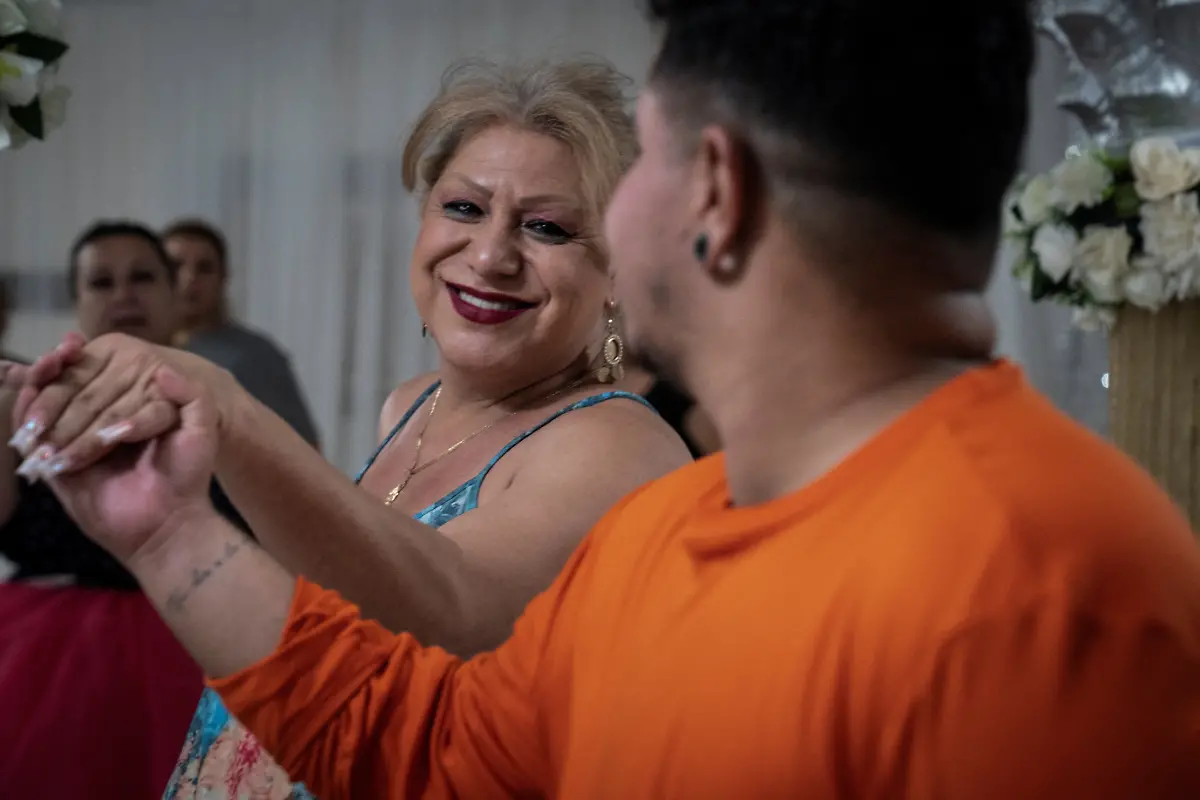 Noemi-Martinez-54-dances-with-Nicolas-Hurtado-during-a-rehearsal-to-Tiempo-de-Vals-by-Chayanne-at-a-ballroom-in-Houston-Texas-U-S-May-13-2025-Martinez-and-other-transgender-Latina-immigrants-were-recently-able-to-celebrate-this-year-as-quinceaneras-literally-translated-as-15-year-olds-thanks-to-the-Organizacion-Latina-de-Trans-en-Texas-a-group-promoting-rights-for-LGBTQ-people-including-transgender-women-from-Latin-America-It-s-a-moment-of-joy-and-excitement-with-a-sense-of-suspense-So-beautiful-because-they-OLTT-are-giving-us-that-space-for-ourselves-to-express-those-beautiful-feelings-Martinez-said-What-we-didn-t-have-as-girls-we-now-have-as-adults-REUTERS-Gabriel-V-Cardenas-SEARCH-CARDENAS-U-S-QUINCEANERAS-FOR-THIS-STORY-SEARCH-WIDER-IMAGE-FOR-ALL-STORIES-THIS-IMAGE-IS-ONLY-FOR-USE-WITH-THE-STORY-USA-LGBTQ-QUINCEANERAS-NO-STANDALONE-USES