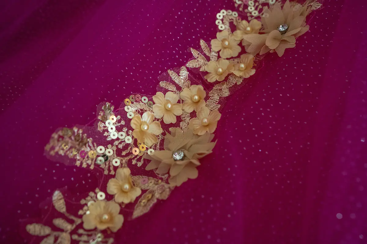 The-quinceanera-dress-of-Kassandra-Rivas-51-at-the-hotel-where-she-is-getting-ready-in-Houston-Texas-U-S-May-14-2025-Rivas-and-other-transgender-Latina-immigrants-were-recently-able-to-celebrate-this-year-as-quinceaneras-thanks-to-the-Organizacion-Latina-de-Trans-en-Texas-a-group-promoting-rights-for-LGBTQ-people-including-transgender-women-from-Latin-America-Something-inside-me-held-a-longing-to-experience-this-moment-as-a-girl-as-a-15-year-old-Rivas-said-I-imagined-myself-standing-before-the-priest-in-church-wearing-a-dress-like-any-other-woman-REUTERS-Gabriel-V-Cardenas-SEARCH-CARDENAS-U-S-QUINCEANERAS-FOR-THIS-STORY-SEARCH-WIDER-IMAGE-FOR-ALL-STORIES-THIS-IMAGE-IS-ONLY-FOR-USE-WITH-THE-STORY-USA-LGBTQ-QUINCEANERAS-NO-STANDALONE-USES