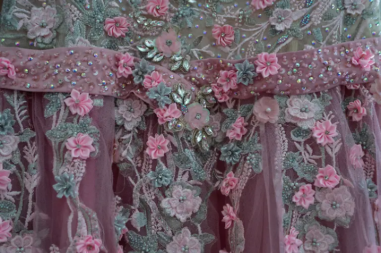 The-quinceanera-dress-of-Noemi-Martinez-54-at-the-hotel-where-she-is-getting-ready-in-Houston-Texas-U-S-May-14-2025-Martinez-and-other-transgender-Latina-immigrants-were-recently-able-to-celebrate-this-year-as-quinceaneras-literally-translated-as-15-year-olds-thanks-to-the-Organizacion-Latina-de-Trans-en-Texas-a-group-promoting-rights-for-LGBTQ-people-including-transgender-women-from-Latin-America-It-s-a-moment-of-joy-and-excitement-with-a-sense-of-suspense-So-beautiful-because-they-OLTT-are-giving-us-that-space-for-ourselves-to-express-those-beautiful-feelings-Martinez-said-What-we-didn-t-have-as-girls-we-now-have-as-adults-REUTERS-Gabriel-V-Cardenas-SEARCH-CARDENAS-U-S-QUINCEANERAS-FOR-THIS-STORY-SEARCH-WIDER-IMAGE-FOR-ALL-STORIES-THIS-IMAGE-IS-ONLY-FOR-USE-WITH-THE-STORY-USA-LGBTQ-QUINCEANERAS-NO-STANDALONE-USES