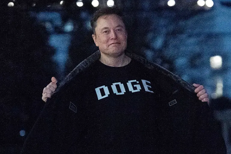 FILE-Elon-Musk-flashes-his-T-shirt-that-reads-DOGE-to-the-media-as-he-walks-on-the-South-Lawn-of-the-White-House-in-Washington-March-9-2025