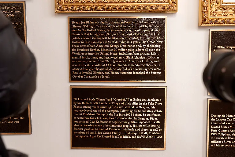 New-plaques-of-explanatory-text-are-seen-beneath-a-framed-portrait-in-the-space-for-former-President-Joe-Biden-on-the-Presidential-Walk-of-Fame-on-the-Colonnade-of-the-White-House-Wednesday-Dec-17-2025-in-Washington