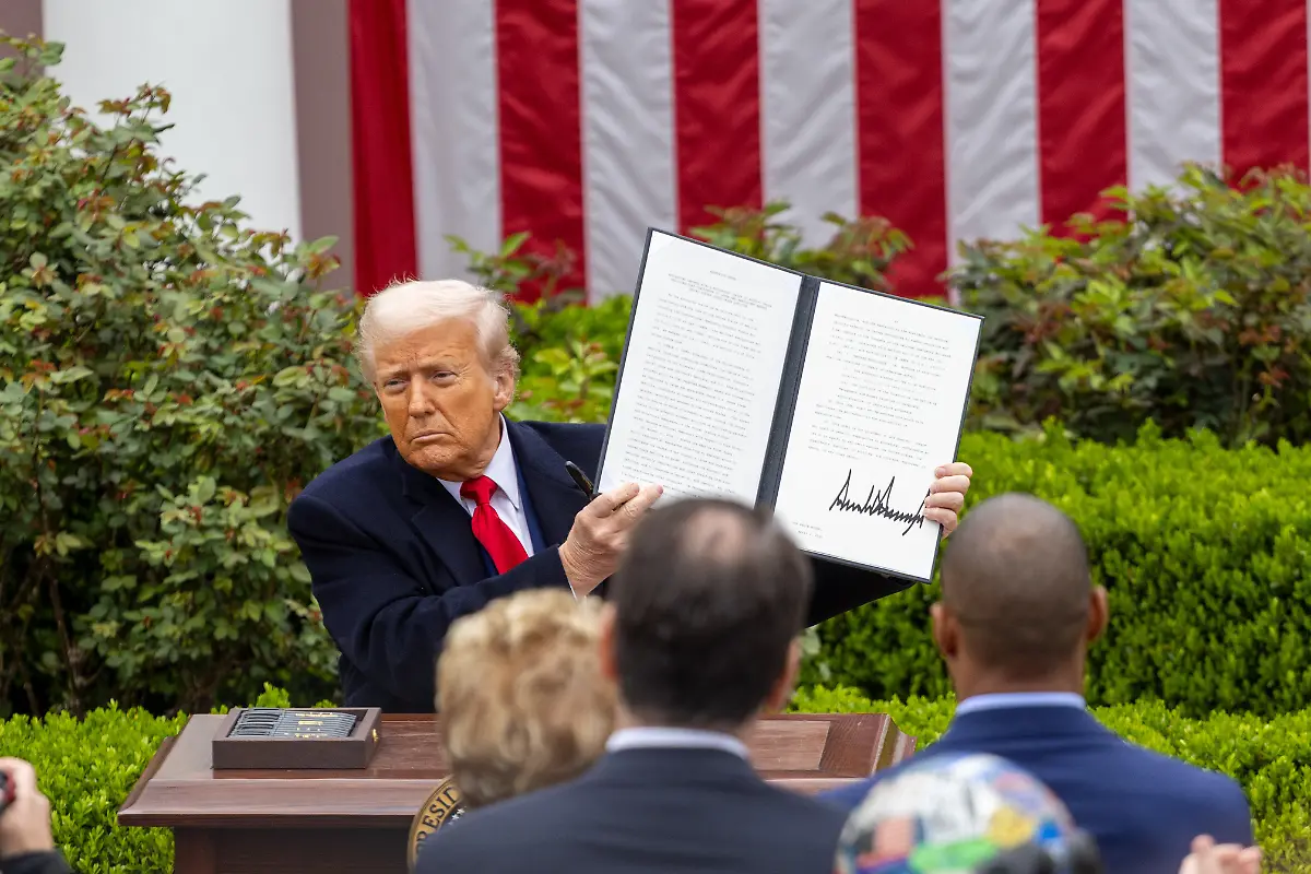 250403-BEIJING-April-3-2025-Xinhua-U-S-President-Donald-Trump-shows-an-executive-order-on-reciprocal-tariffs-at-the-Rose-Garden-of-the-White-House-in-Washington-D-C-the-United-States-on-April-2-2025-Amid-widespread-opposition-U-S-President-Donald-Trump-on-Wednesday-signed-an-executive-order-on-the-so-called-reciprocal-tariffs-imposing-a-10-percent-minimum-baseline-tariff-and-higher-rates-on-certain-trading-partners