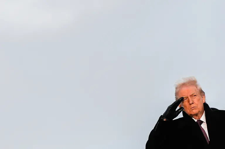 President-Donald-Trump-salutes-as-a-carry-team-moves-the-transfer-case-with-the-remains-of-civilian-interpreter-Ayad-Mansoor-Sakat-who-was-killed-in-an-attack-in-Syria-during-a-casualty-return-Wednesday-Dec-17-2025-at-Dover-Air-Force-Base-Del