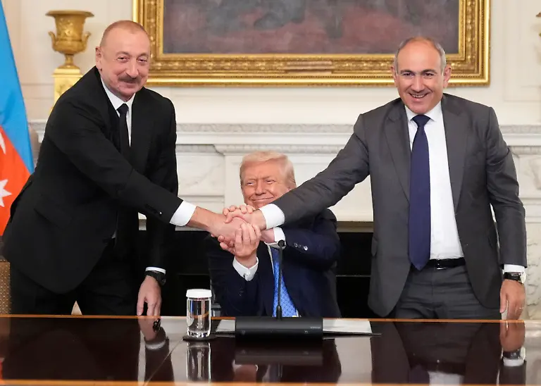 President-Donald-Trump-center-shakes-hands-with-Armenian-Prime-Minister-Nikol-Pashinyan-right-and-Azerbaijan-President-Ilham-Aliyev-during-a-trilateral-signing-ceremony-in-the-State-Dining-Room-of-the-White-House-Friday-Aug-8-2025-in-Washington