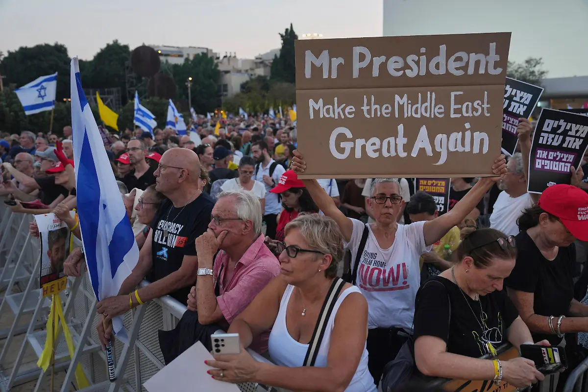 A-demonstrator-holds-up-a-sign-with-a-message-to-the-U-S-President-Donald-Trump-during-a-rally-calling-for-the-end-of-the-war-and-immediate-release-of-hostages-held-by-Hamas-in-the-Gaza-Strip-in-Tel-Aviv-Israel-Thursday-July-24-2025
