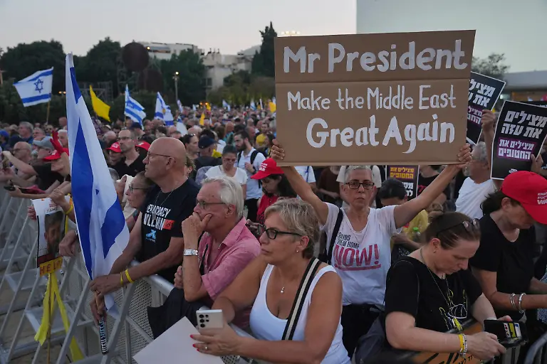 A-demonstrator-holds-up-a-sign-with-a-message-to-the-U-S-President-Donald-Trump-during-a-rally-calling-for-the-end-of-the-war-and-immediate-release-of-hostages-held-by-Hamas-in-the-Gaza-Strip-in-Tel-Aviv-Israel-Thursday-July-24-2025
