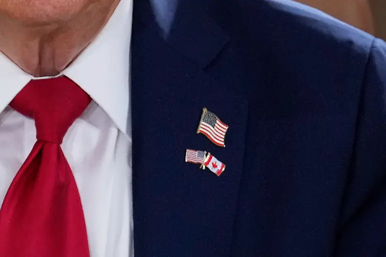 President-Donald-Trump-wears-a-pin-with-the-flags-of-Canada-and-the-United-States-as-he-participates-in-a-session-of-the-G7-Summit-Monday-June-16-2025-in-Kananaskis-Canada