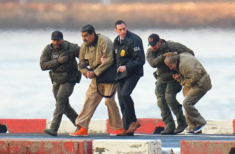 Photo-by-XNY-STAR-MAX-IPx-2026-1-5-26-Nicolas-Maduro-and-his-wife-Cilia-Flores-are-seen-in-handcuffs-after-landing-at-a-Manhattan-helipad-escorted-by-heavily-armed-Federal-agents-as-they-make-their-way-into-an-armored-car-en-route-to-a-Federal-courthouse-in-Manhattan-on-January-5-2026-in-New-York-City
