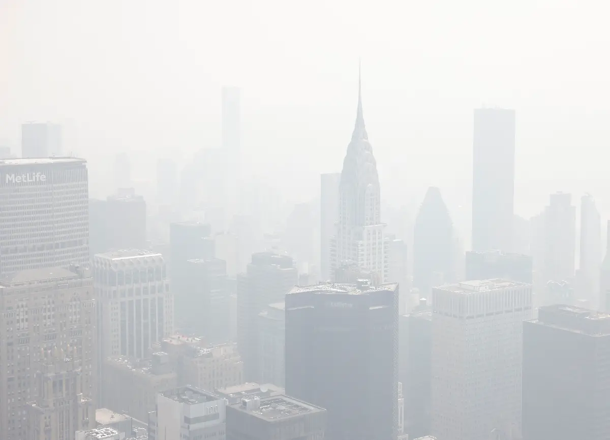 Tourists-visit-the-observation-deck-of-the-Empire-State-Building-as-haze-and-smoke-due-to-on-going-wildfires-in-Canada-shroud-the-views-of-the-Chrysler-Building-and-the-Manhattan-skyline-on-Friday-June-30-2023-in-New-York-City