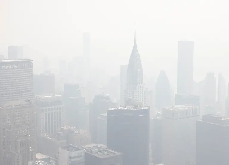 Tourists-visit-the-observation-deck-of-the-Empire-State-Building-as-haze-and-smoke-due-to-on-going-wildfires-in-Canada-shroud-the-views-of-the-Chrysler-Building-and-the-Manhattan-skyline-on-Friday-June-30-2023-in-New-York-City