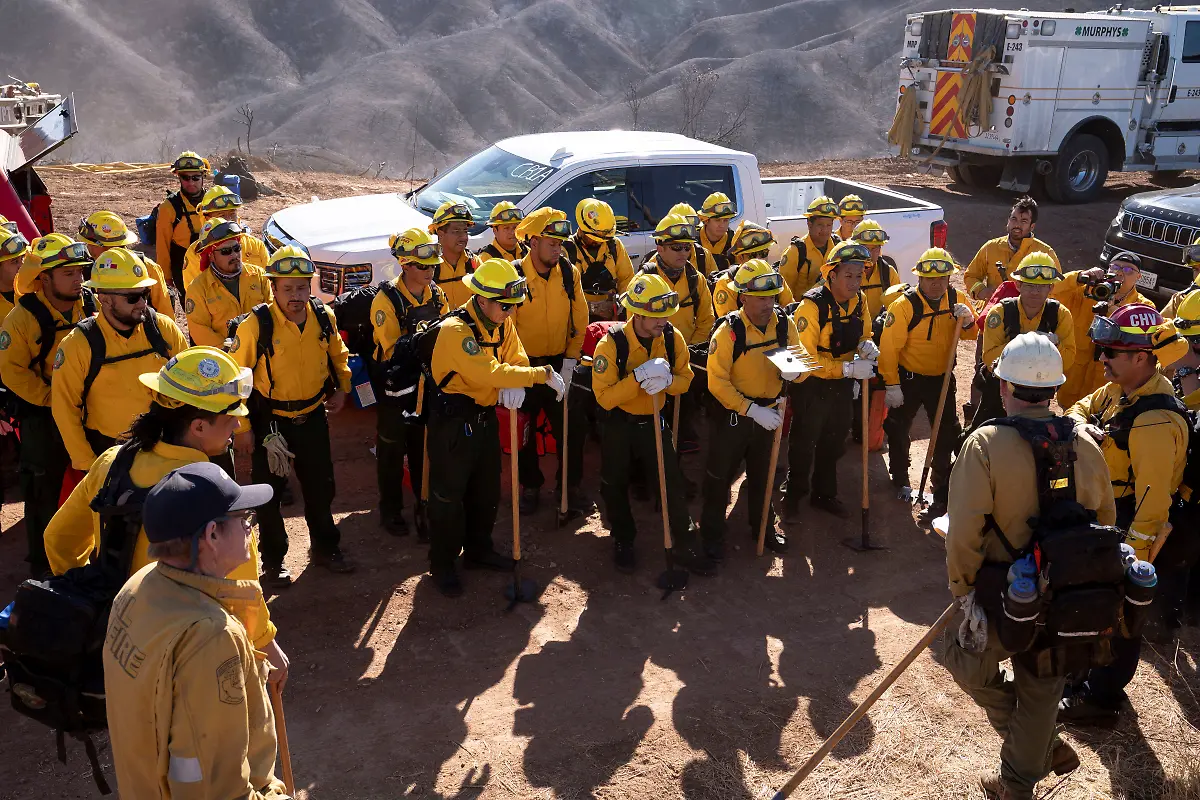 Firefighters-from-Mexico-listen-to-a-briefing-before-cutting-a-containment-line-in-the-Tarzana-area-during-the-Palisades-Fire-in-Los-Angeles-California-U-S-January-13-2025