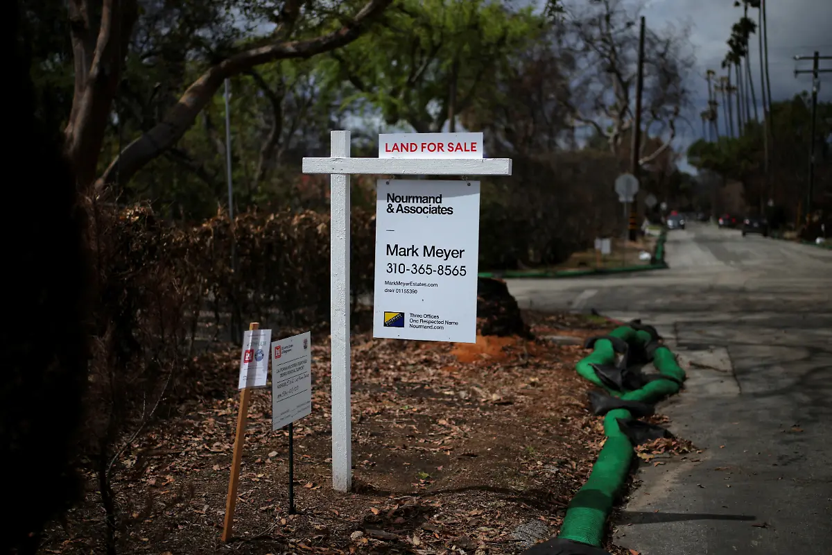 A-land-for-sale-sign-marks-a-property-burned-during-the-Eaton-Fire-in-Altadena-California-U-S-March-13-2025