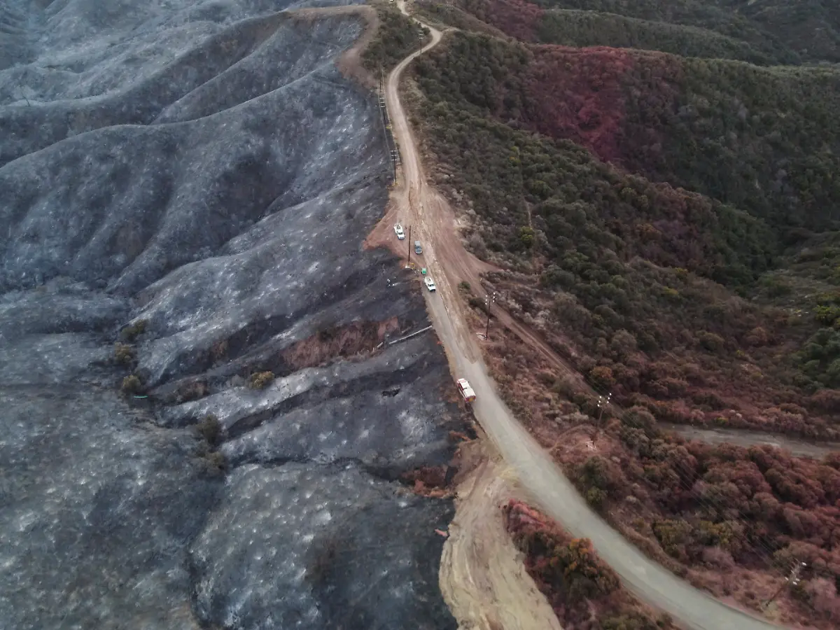 A-drone-view-shows-a-CalFire-crew-mopping-up-hotspots-from-the-burn-scar-of-the-Palisades-Fire-near-Mulholland-Drive-in-Los-Angeles-California-U-S-January-15-2025