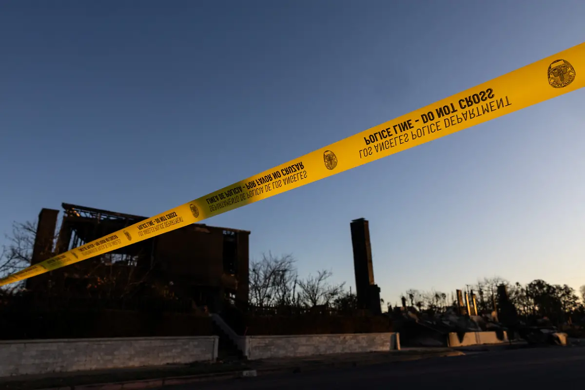 A-police-yellow-tape-installed-to-restrict-the-access-of-an-area-damaged-by-the-Palisades-Fire-is-seen-at-the-Pacific-Palisades-neighborhood-in-Los-Angeles-California-U-S-January-13-2025