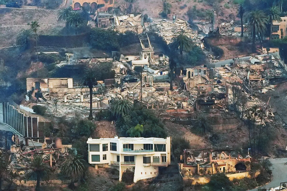 The-devastation-from-the-Palisades-Fire-is-seen-from-the-air-as-a-house-remains-standing-at-bottom-in-the-Pacific-Palisades-neighborhood-of-Los-Angeles-Jan-9-2025-AP-Photo-Mark-J