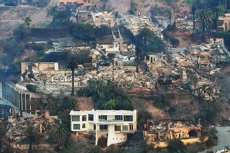 The-devastation-from-the-Palisades-Fire-is-seen-from-the-air-as-a-house-remains-standing-at-bottom-in-the-Pacific-Palisades-neighborhood-of-Los-Angeles-Jan-9-2025-AP-Photo-Mark-J