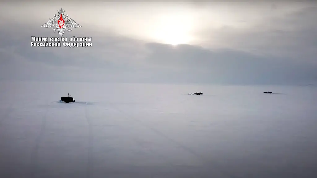 In-this-handout-photo-taken-from-a-footage-released-by-Russian-Defense-Ministry-Press-Service-on-March-26-2021-Russian-nuclear-submarines-break-through-the-Arctic-ice-during-military-drills-at-an-unspecified-location-Russian-President-Vladimir-Putin-on-Friday-hailed-the-military-s-performance-during-recent-Arctic-drills-part-of-Moscow-s-efforts-to-expand-its-presence-in-the-polar-region