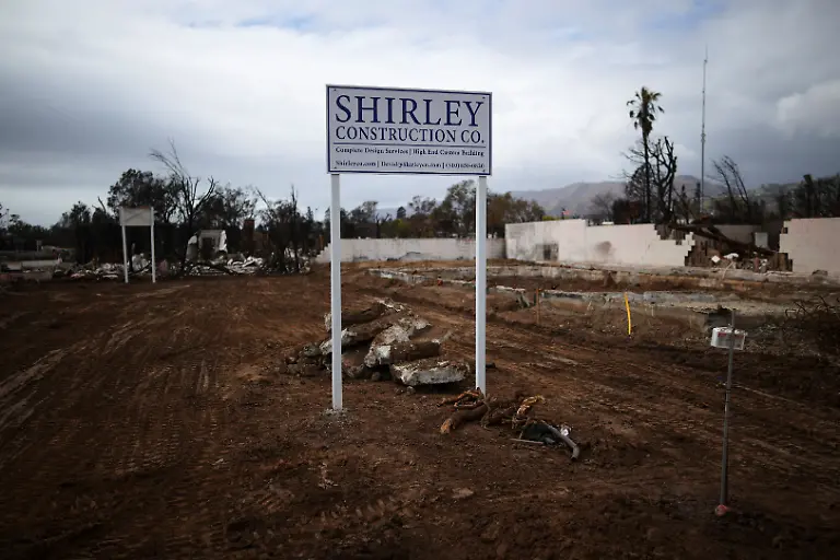 A-sign-advertising-a-construction-company-stands-on-a-plot-of-land-following-the-Palisades-Fire-in-the-Pacific-Palisades-Los-Angeles-California-U-S-March-17-2025