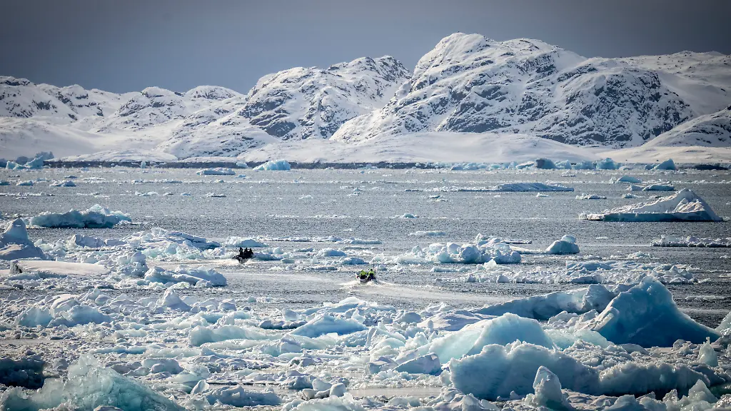 NUUK-2025-03-30-Tva-motorbatar-passerar-mellan-isberg-och-packis-i-havet-utanfoer-Nuuk-pa-Groenland-i-slutet-pa-mars-2025
