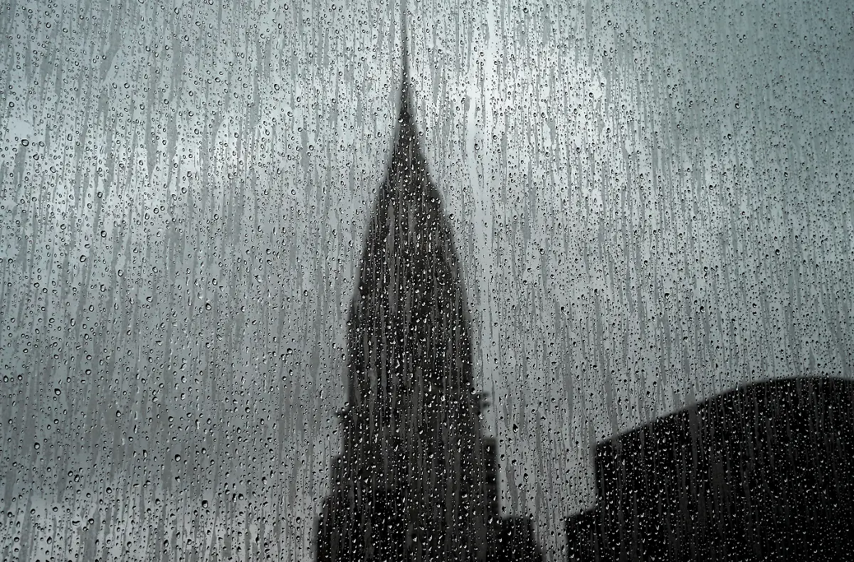 The-Chrysler-Building-is-seen-through-a-rain-covered-high-rise-window-on-August-13-2018-The-Chrysler-Building-is-an-Art-Decostyle-skyscraper-located-on-the-East-Side-of-Midtown-Manhattan-in-New-York-City-and-one-of-the-city-landmarks-Photo-by-TIMOTHY-A