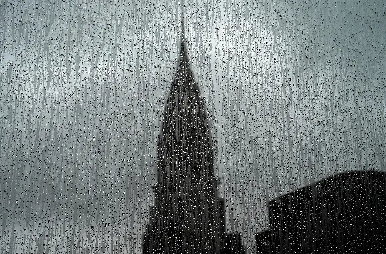 The-Chrysler-Building-is-seen-through-a-rain-covered-high-rise-window-on-August-13-2018-The-Chrysler-Building-is-an-Art-Decostyle-skyscraper-located-on-the-East-Side-of-Midtown-Manhattan-in-New-York-City-and-one-of-the-city-landmarks-Photo-by-TIMOTHY-A