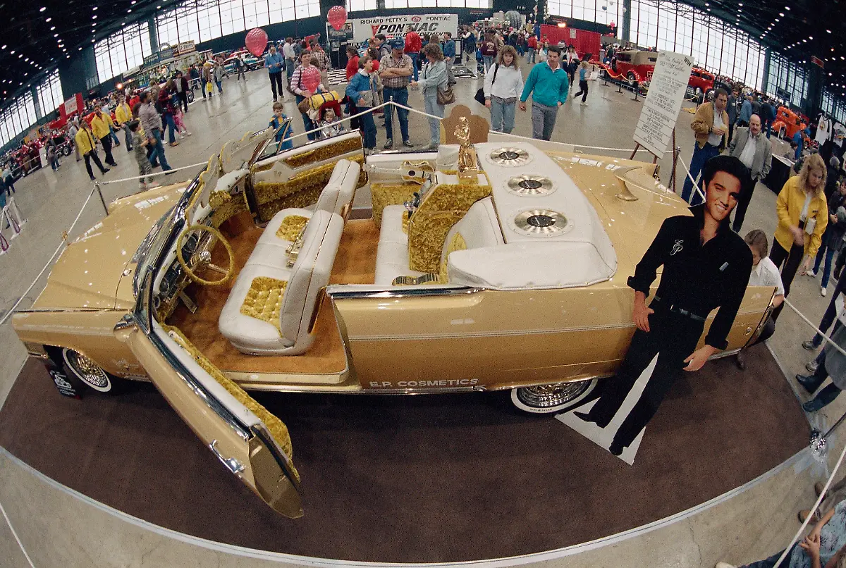 Crowds-at-an-auto-show-look-at-a-custom-made-1965-gold-Cadillac-Eldorado-designed-by-George-Barris-and-Elvis-Presley-in-Chicago-Jan-17-1987-The-car-designed-before-Presley-s-death-has-three-gold-Elvis-Presley-45-rpm-records-imbedded-in-the-rear-headrest-and-has-a-body-telephone-television-bumpers-and-grill-covered-with-14-karat-gold-leaf-The-car-is-touring-the-country-appearing-at-malls-and-auto-shows
