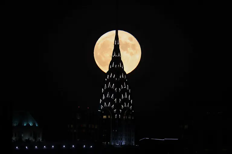 NEW-YORK-NY-OCTOBER-20-Full-moon-also-known-as-Hunter-s-Moon-rises-behind-the-Chrysler-building-in-Manhattan-of-New-York-City-United-States-on-October-20-2021