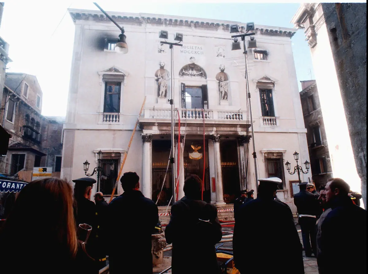 Firefighters-and-police-officers-stand-in-front-of-La-Fenice-opera-house-burnt-out-by-a-savage-fire-in-Venice-Tuesday-Jan-30-1996-The-facade-looks-intact-but-the-204-year-old-theatre-opened-in-1792-and-destroyed-by-two-previous-fires-one-during-contstruction-and-another-in-1836-was-completely-destroyed-inside