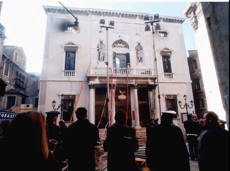 Firefighters-and-police-officers-stand-in-front-of-La-Fenice-opera-house-burnt-out-by-a-savage-fire-in-Venice-Tuesday-Jan-30-1996-The-facade-looks-intact-but-the-204-year-old-theatre-opened-in-1792-and-destroyed-by-two-previous-fires-one-during-contstruction-and-another-in-1836-was-completely-destroyed-inside