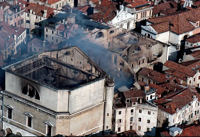 Smoke-still-rises-from-La-Fenice-opera-house-in-this-picture-taken-from-a-helicopter-in-Venice-Tuesday-Jan-30-1996-The-interior-of-the-opera-house-was-completely-destroyed-by-a-fire-which-started-Monday-evening-Jan-29-1996