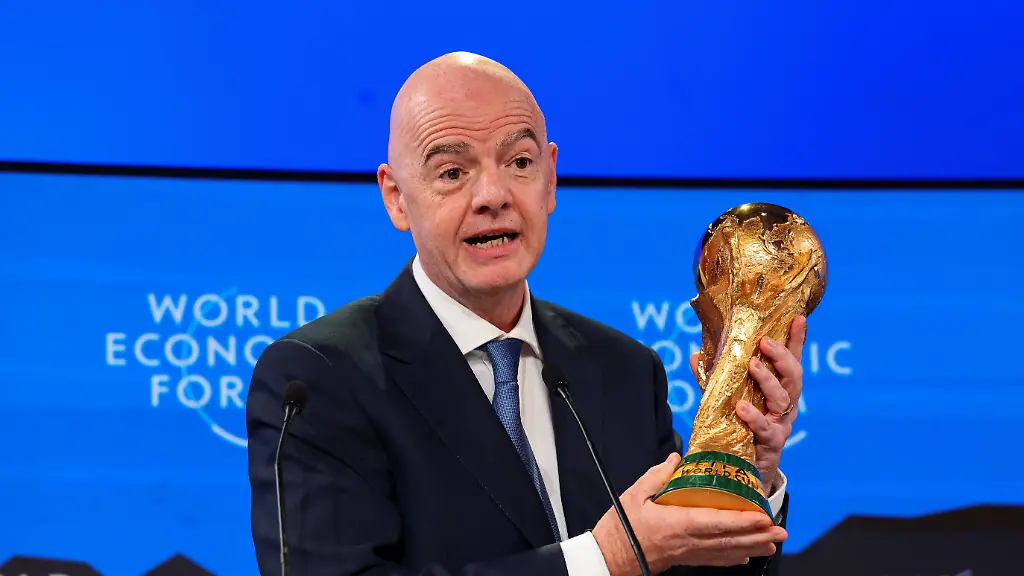 FIFA-President-Gianni-Infantino-holds-the-FIFA-World-Cup-trophy-as-he-attends-the-56th-annual-World-Economic-Forum-WEF-meeting-in-Davos-Switzerland-January-22-2026