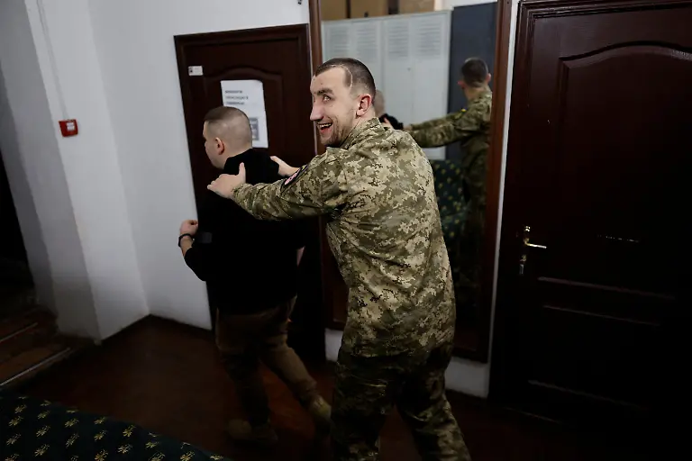 Mykola-Kobyliuk-Ukrainian-serviceman-and-manager-of-the-Veterans-Theatre-group-assists-Ukrainian-soldier-Andrii-Onopriienko-31-who-lost-both-eyes-in-2023-and-is-also-a-member-of-the-theatre-group-amid-Russia-s-attack-on-Ukraine-in-Kyiv-Ukraine-December-4-2025-Like-the-other-veterans-in-his-Kyiv-based-group-of-around-15-actors-Onopriienko-has-found-healing-and-fulfilment-on-stage-after-a-friend-told-him-about-a-theatre-looking-for-injured-veterans-and-suggested-he-join-Yes-we-might-not-have-an-arm-or-legs-or-eyes-but-we-aren-t-giving-up-he-said-It-s-rehabilitation-and-socialisation-it-s-positive-emotions-REUTERS-Alina-Smutko-SEARCH-UKRAINE-SMUTKO-THEATRE-FOR-THIS-STORY-SEARCH-WIDER-IMAGE-FOR-ALL-STORIES