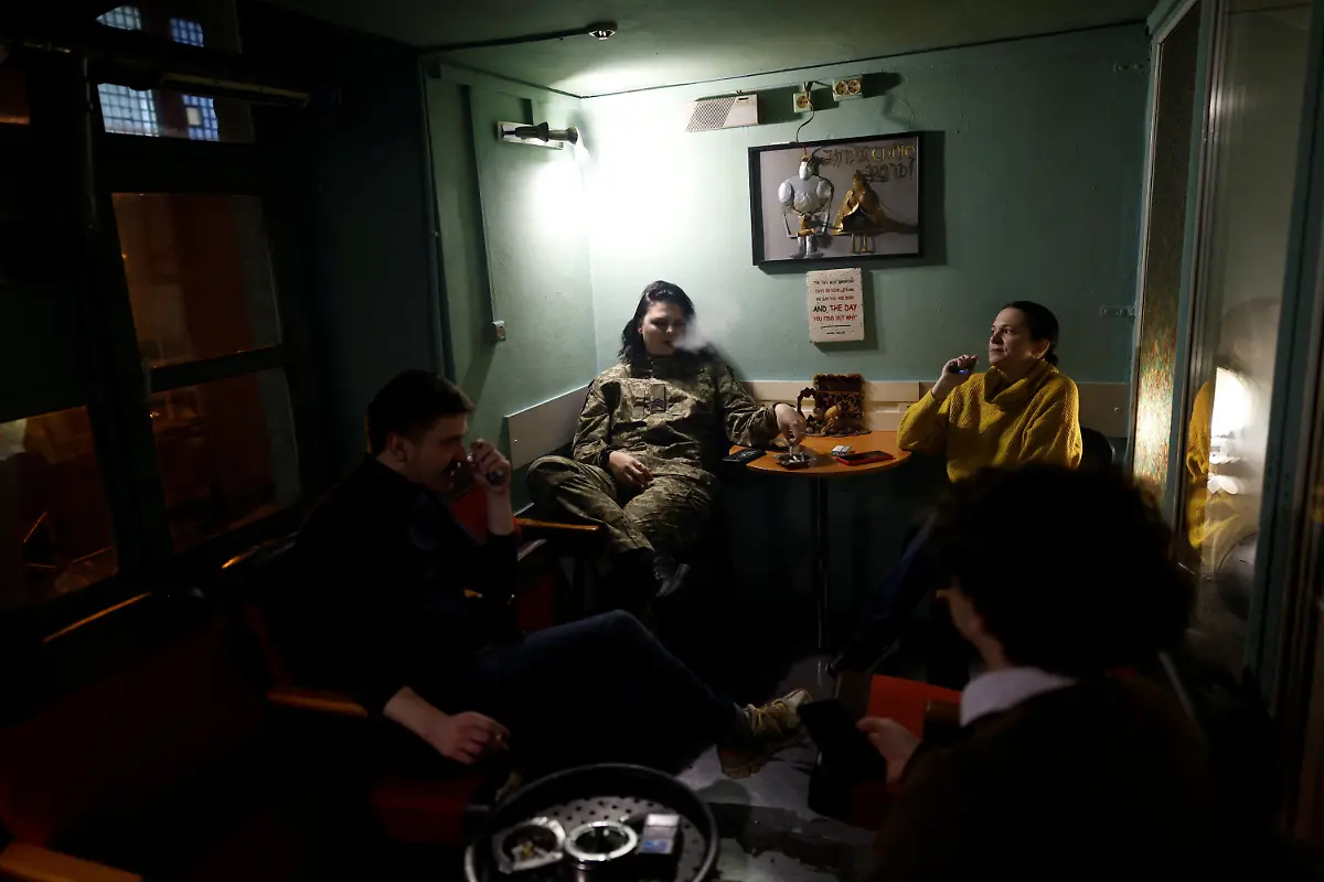 Inna-Korolenko-26-a-member-of-the-Veterans-Theatre-group-smokes-with-the-theatre-s-staff-before-the-premiere-of-an-18th-century-Ukrainian-parody-of-Virgil-s-Aeneid-amid-Russia-s-attack-on-Ukraine-in-Kyiv-Ukraine-December-4-2025-Fellow-member-and-veterans-psychologist-Yehor-Babenko-27-said-the-transformative-trauma-of-serious-injury-often-compels-people-to-seek-meaning-in-something-new-He-said-it-was-critical-for-his-fellow-comrades-to-understand-that-life-does-not-simply-end-after-a-serious-injury-Sometimes-you-understand-it-s-the-opposite-that-it-just-starts-getting-going-REUTERS-Alina-Smutko-SEARCH-UKRAINE-SMUTKO-THEATRE-FOR-THIS-STORY-SEARCH-WIDER-IMAGE-FOR-ALL-STORIES