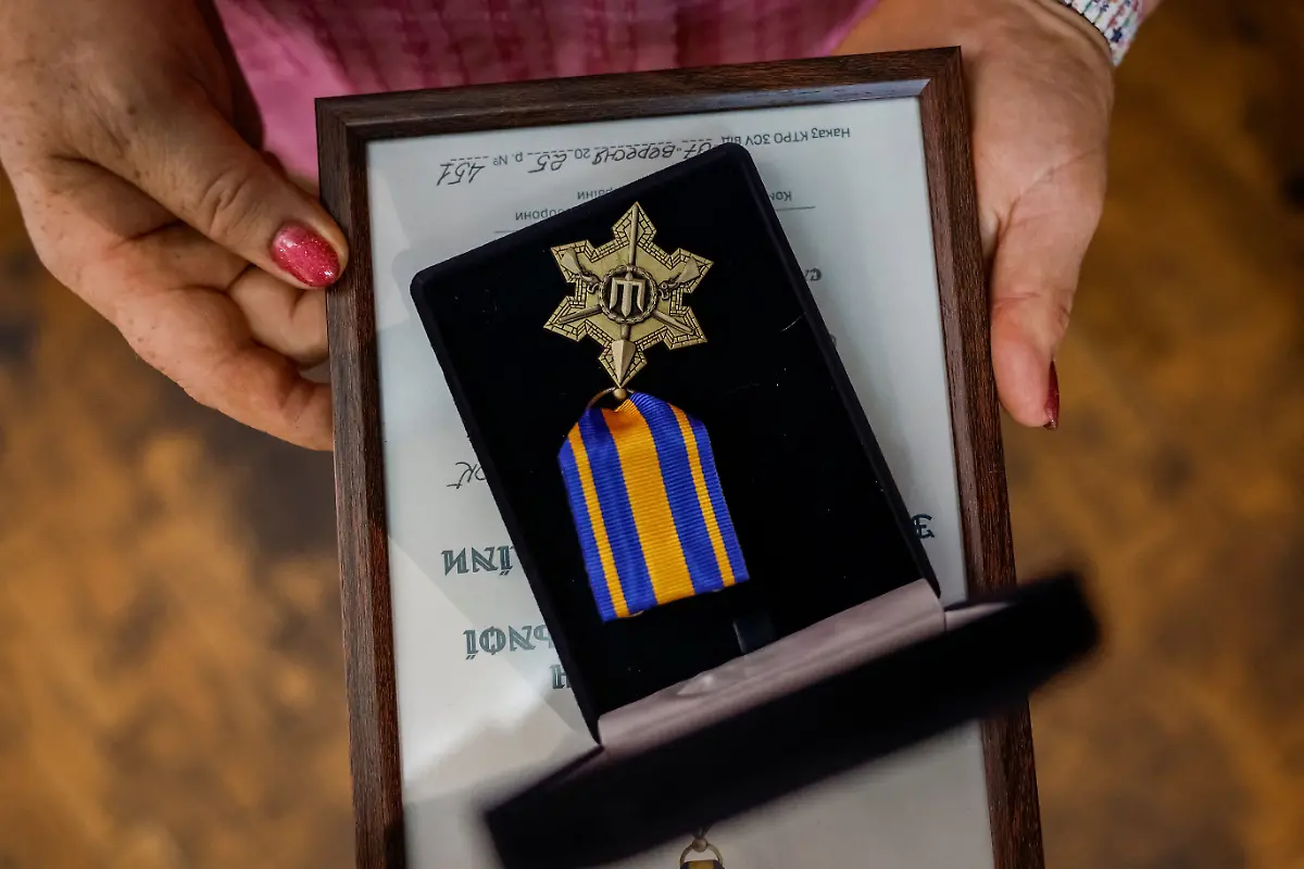 Nataliia-Plokhotniuk-61-a-member-of-the-Veterans-Theatre-group-holds-an-awarded-medal-she-got-during-rehersal-for-an-18th-century-Ukrainian-parody-of-Virgil-s-Aeneid-amid-Russia-s-attack-on-Ukraine-in-Kyiv-Ukraine-September-10-2025-Fellow-member-and-veterans-psychologist-Yehor-Babenko-27-said-the-transformative-trauma-of-serious-injury-often-compels-people-to-seek-meaning-in-something-new-He-said-it-was-critical-for-his-fellow-comrades-to-understand-that-life-does-not-simply-end-after-a-serious-injury-Sometimes-you-understand-it-s-the-opposite-that-it-just-starts-getting-going-REUTERS-Alina-Smutko-SEARCH-UKRAINE-SMUTKO-THEATRE-FOR-THIS-STORY-SEARCH-WIDER-IMAGE-FOR-ALL-STORIES