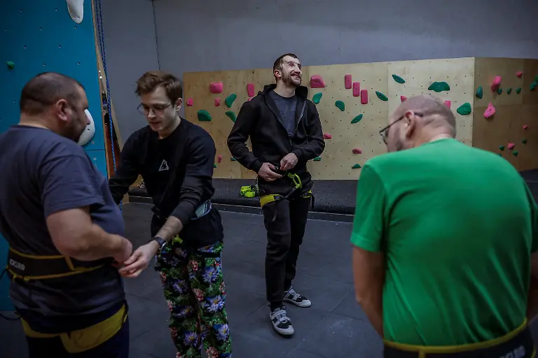 Ukrainian-soldier-Andrii-Onopriienko-center-31-who-lost-both-eyes-in-2023-and-is-now-a-member-of-the-Veterans-Theatre-group-attends-rehabilitation-classes-with-fellow-veterans-at-a-climbing-wall-amid-Russia-s-attack-on-Ukraine-in-Kyiv-Ukraine-December-2-2025-Like-the-other-veterans-in-his-Kyiv-based-group-of-around-15-actors-Onopriienko-has-found-healing-and-fulfilment-on-stage-after-a-friend-told-him-about-a-theatre-looking-for-injured-veterans-and-suggested-he-join-Yes-we-might-not-have-an-arm-or-legs-or-eyes-but-we-aren-t-giving-up-he-said-It-s-rehabilitation-and-socialisation-it-s-positive-emotions-REUTERS-Alina-Smutko-SEARCH-UKRAINE-SMUTKO-THEATRE-FOR-THIS-STORY-SEARCH-WIDER-IMAGE-FOR-ALL-STORIES