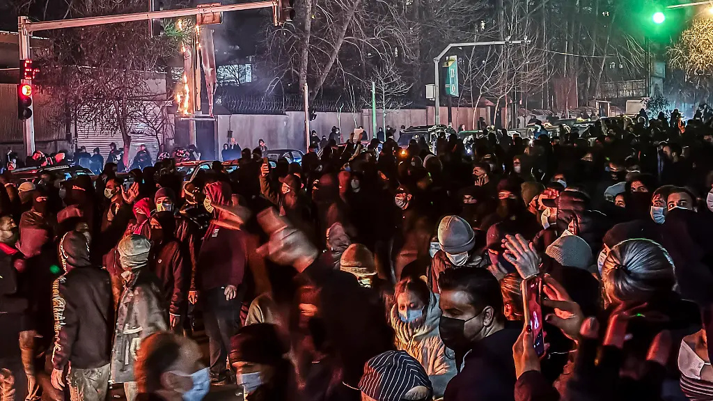Iranians-gather-while-blocking-a-street-during-a-protest-in-Tehran-Iran-on-January-9-2026-The-nationwide-protests-started-in-Tehran-s-Grand-Bazaar-against-the-failing-economic-policies-in-late-December-which-spread-to-universities-and-other-cities-and-included-economic-slogans-to-political-and-anti-government-ones